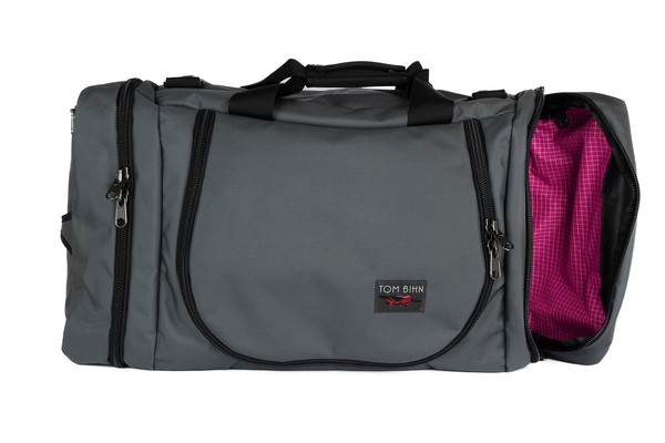 A Nebulous Grey (medium grey) Ballistic Aeronaut 45 with the end pocket open showing the Cerise (pink) Halcyon.